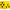 A bright yellow cube-shaped archery target with black circular dots and a recessed cutout on one face, shown on a plain white background.