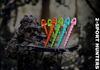 Person in camouflage holding a bow with colorful target pins, brand '2-Sport Hunters' visible