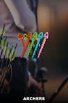 Colorful archery pins with a blurred archer in the background.