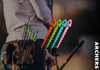 Colorful archery arrows held by an archer with a blurred background