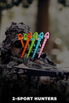 Person in camouflage holding a crossbow with colorful nocks, blurred background